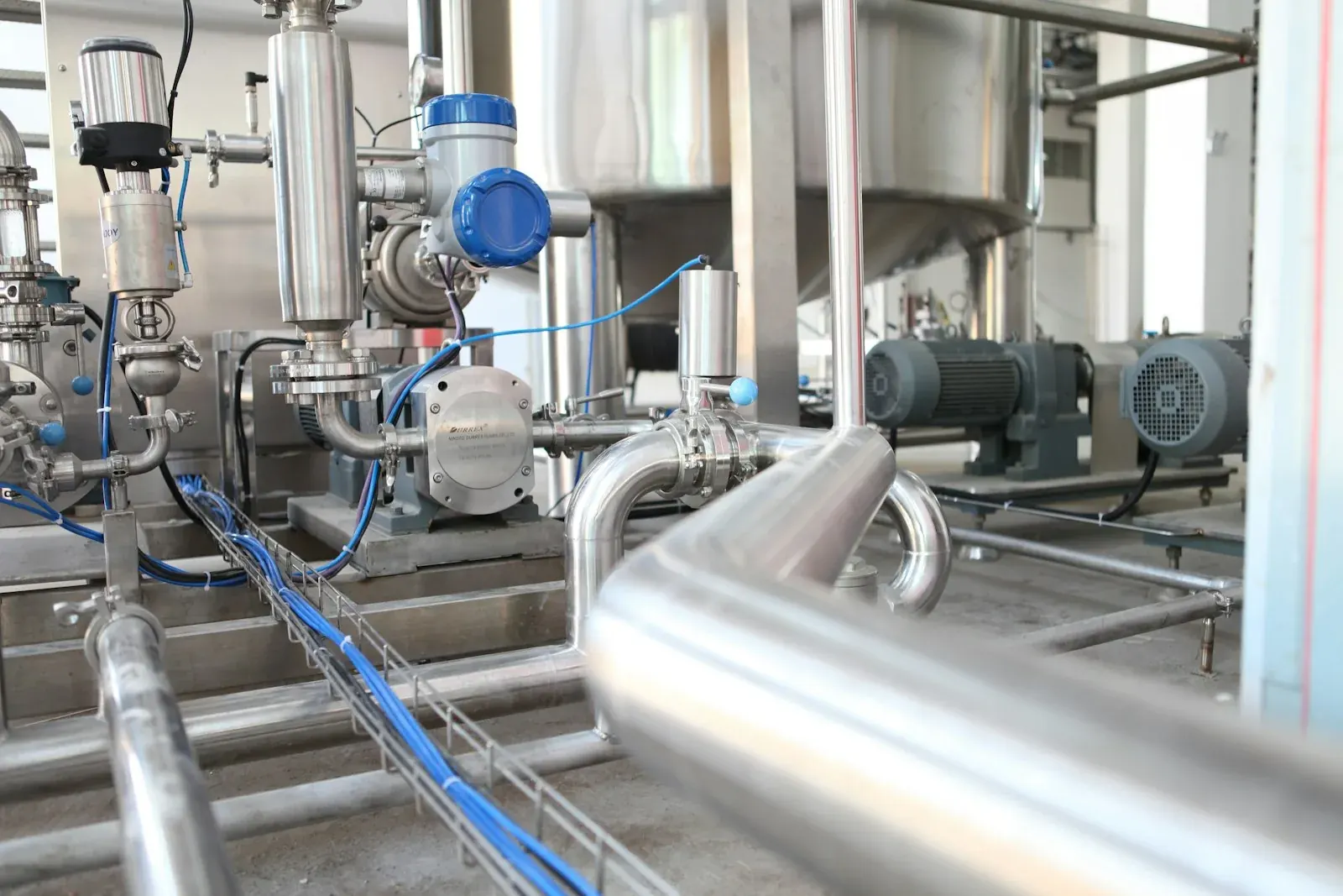 Chemist adjusting flow reactor tubing and pump settings during process development