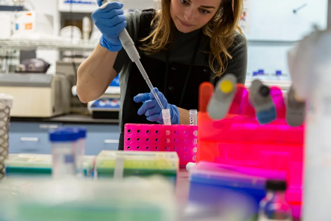 Scientist using a pipette in a chemistry research laboratory